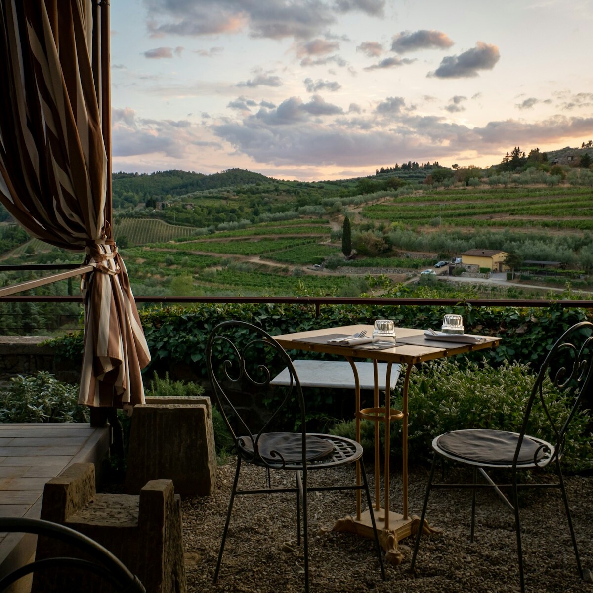 a table and chairs on a patio with a view